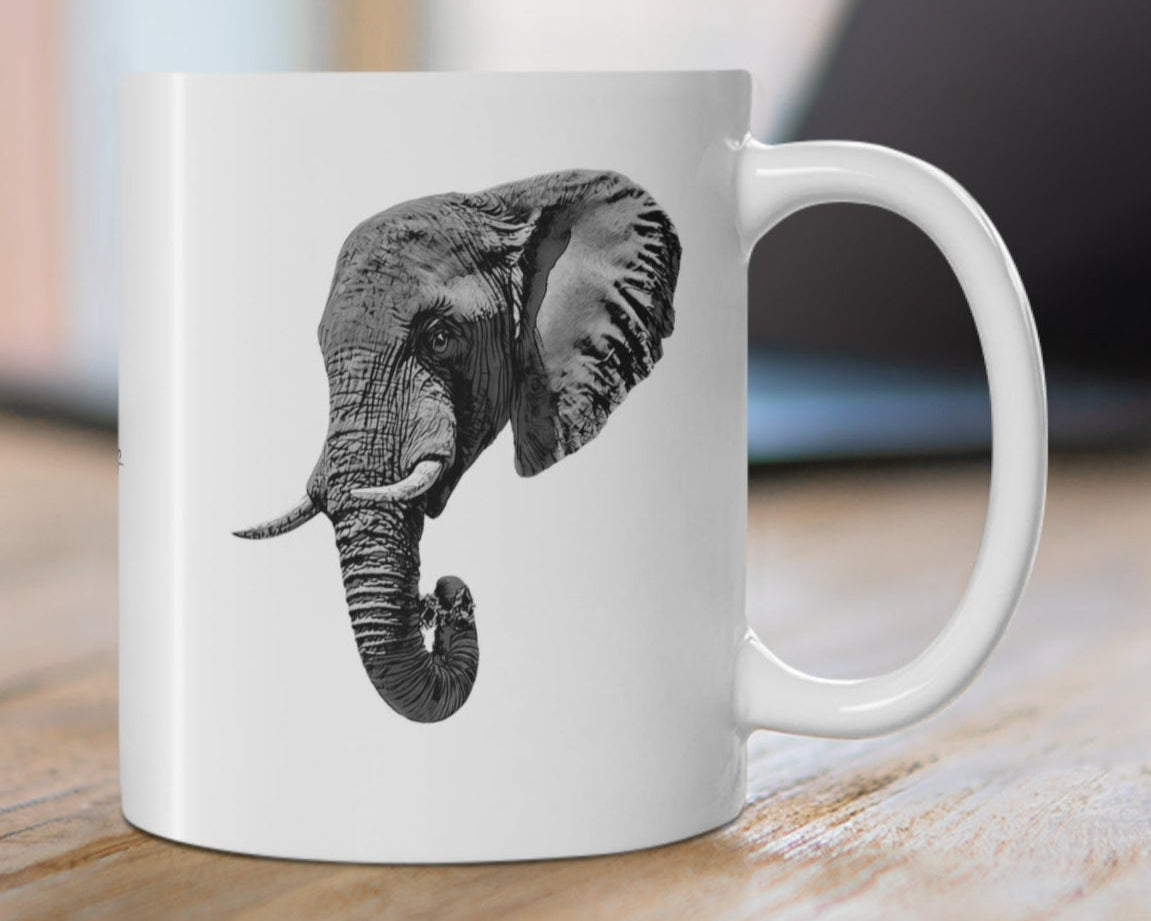 White mug with an elephant design on a wooden desk