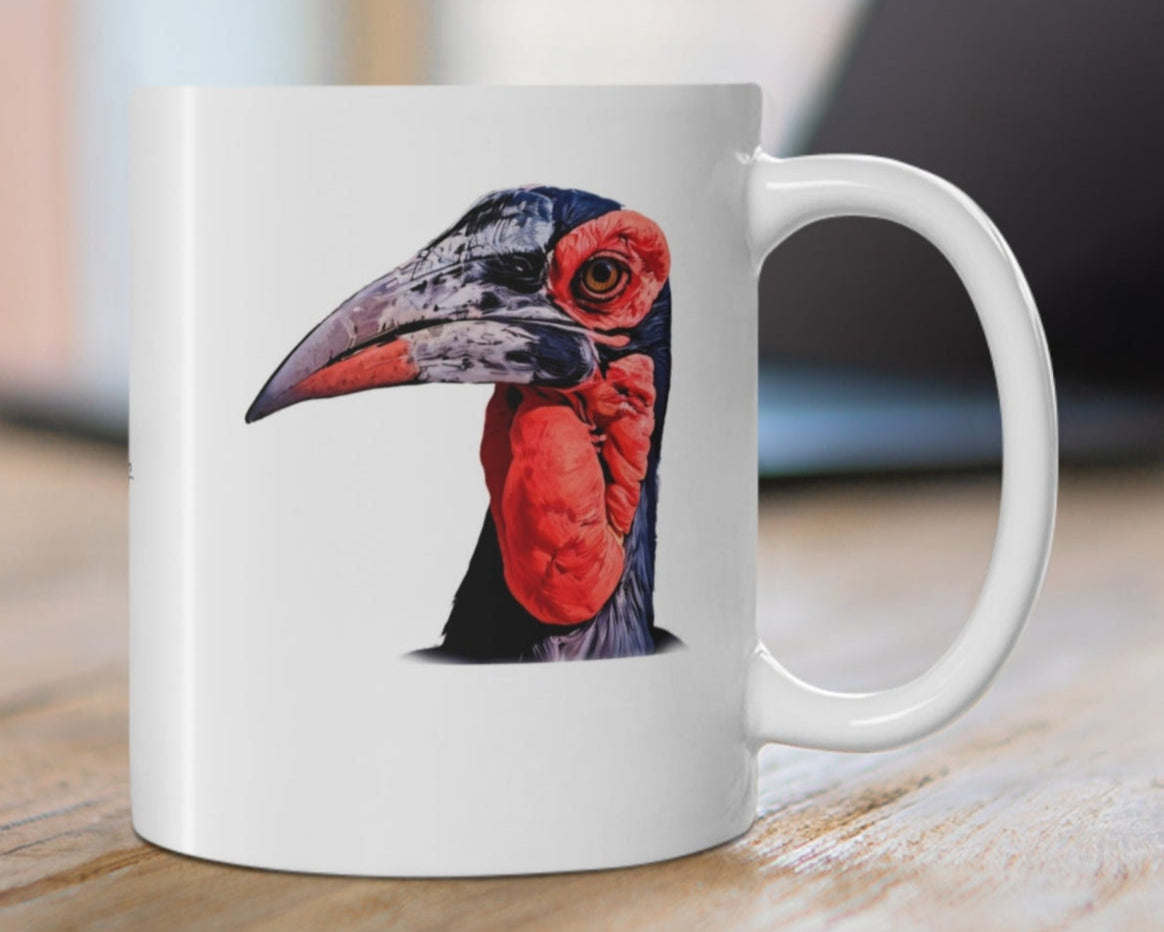 White mug with a bird design on a wooden surface
