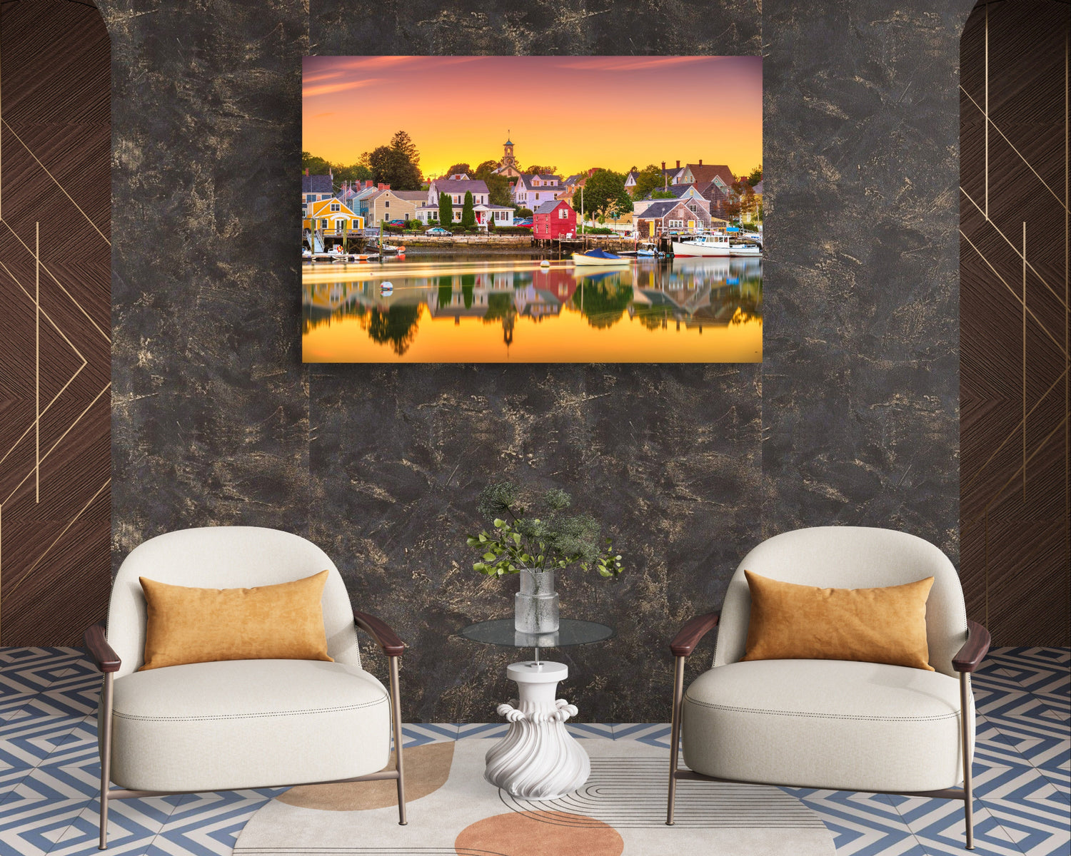 Two white armchairs with gold cushions in a room with a large wall-mounted painting of a sunset over a harbor.
